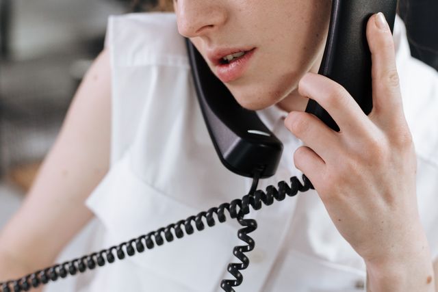 Close-up of a person man talking on two phones