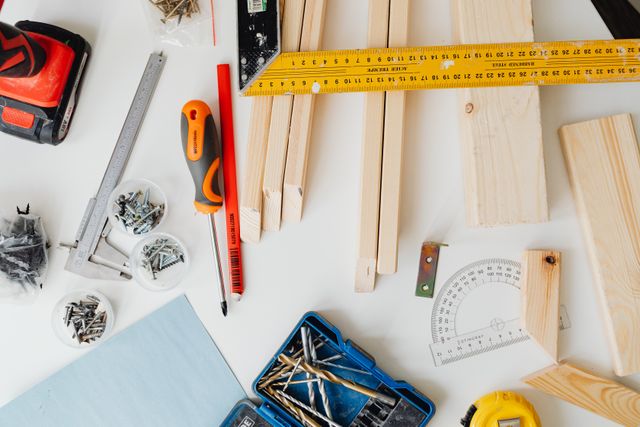 Top view of carpentry tools and wooden planks