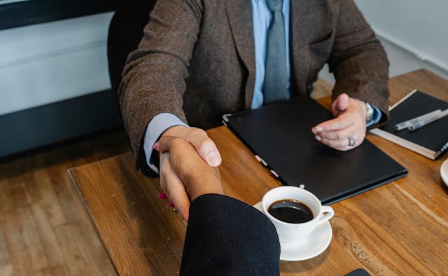 handshake over coffee