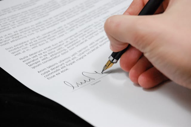 person signing a legal document