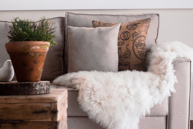 sofa with fur throws and decorative pillows