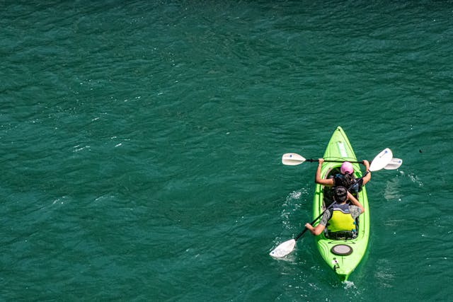 two people kayaking in clear water