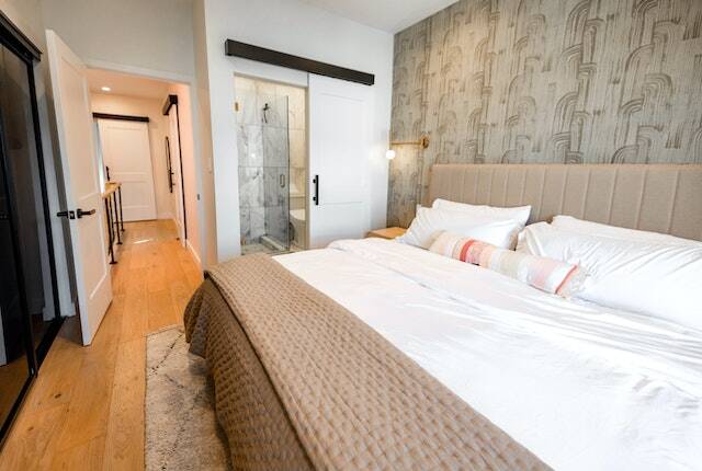 white bed linen on bed in brown neutral room